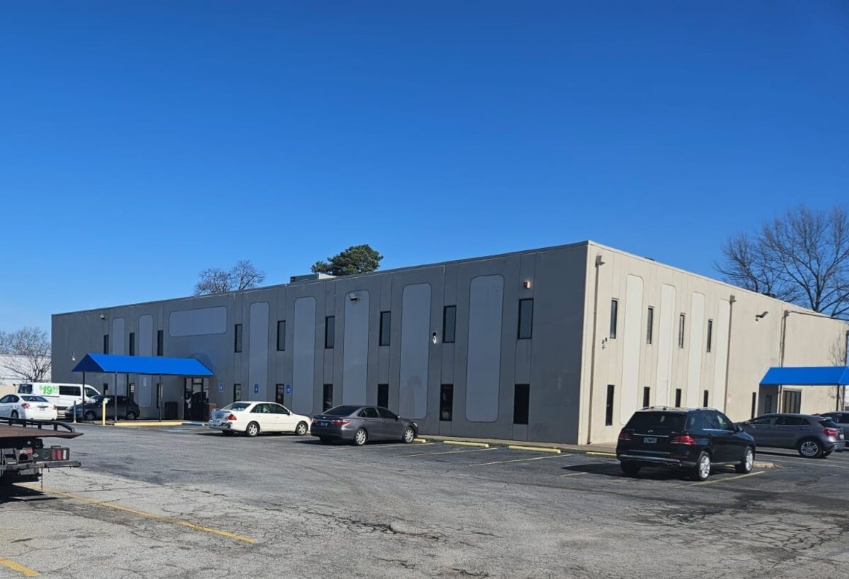 Exterior view of the Airport Center building and blue entrance awnings.
