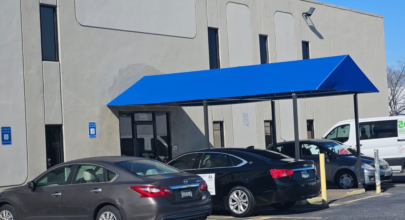Exterior of Airport Center with blue entrance awning.