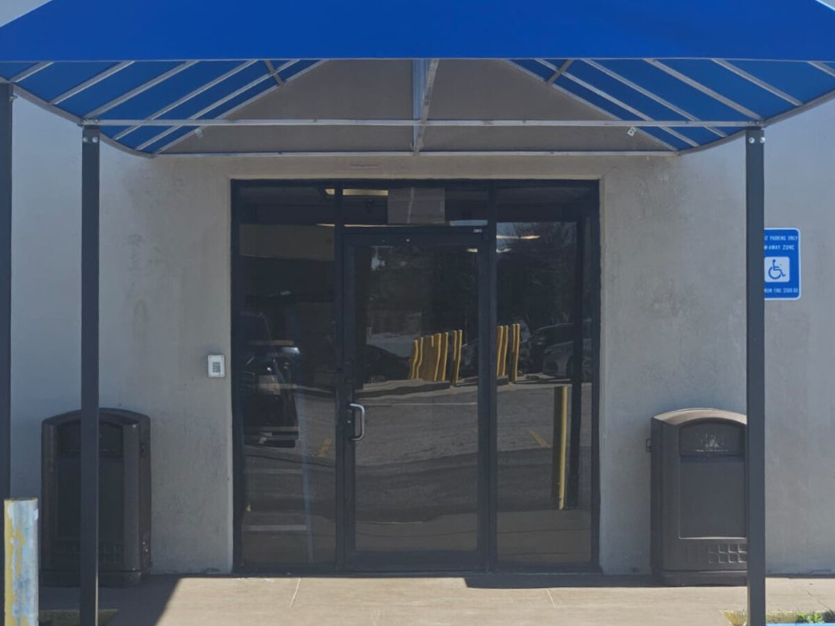 Blue awning and main entrance at Airport Center.